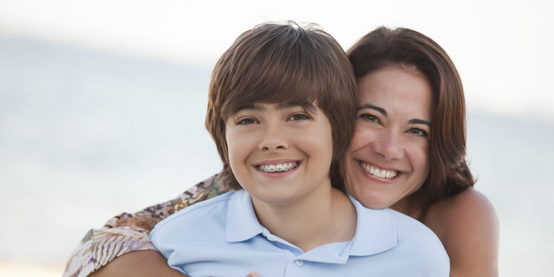 mother and son both showing the results of their orthodontic treatment