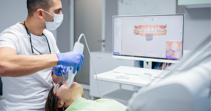 Dentist performing an imaging of a woman’s teeth