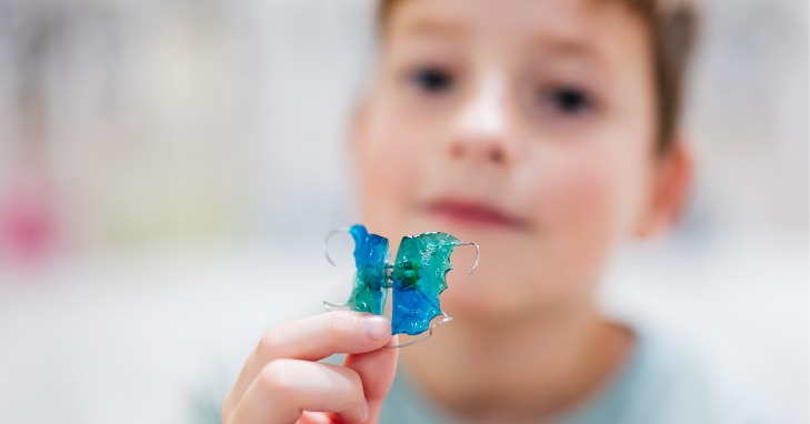 boy showing his Hawley retainer