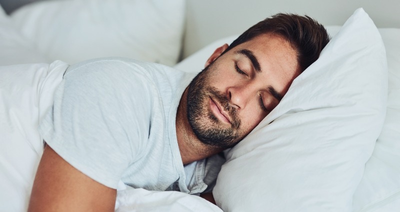 A man getting a good nights sleep after fixing sleep problems with adult orthodontics