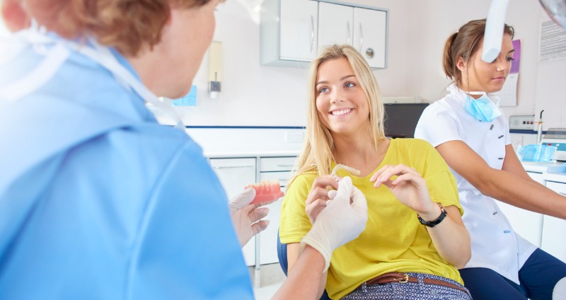 Young girl at a orthodontic consultation discussing invisalign