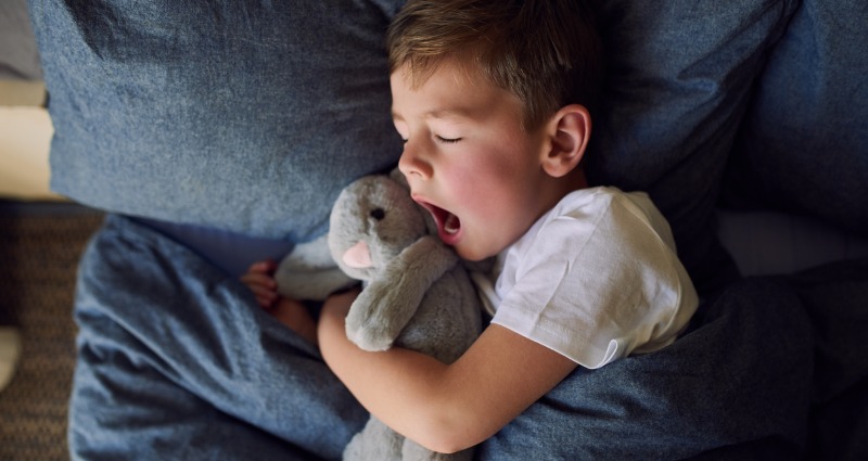 A child grinding their teeth in their sleep.