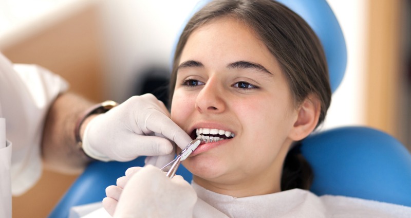 Teen girl with braces on her bottom teeth only