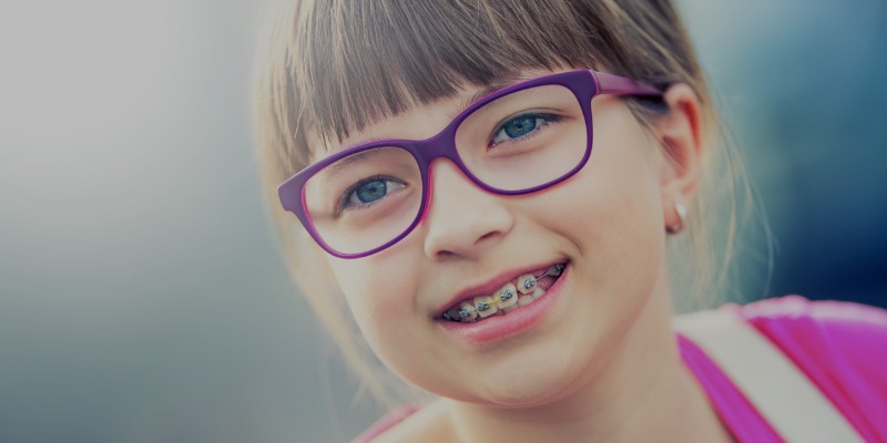 Young girl with braces and purple glasses