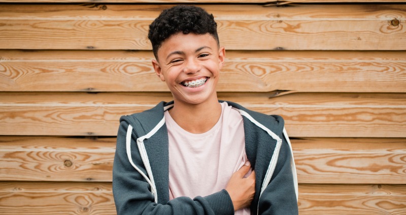 Teenage boy smiling after getting orthodontic braces put on