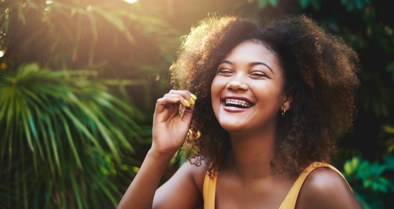 Young girl enjoying herself & smiling with braces 