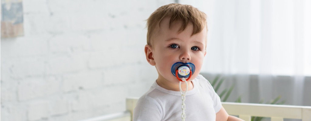 toddler with a dummy in his mouth