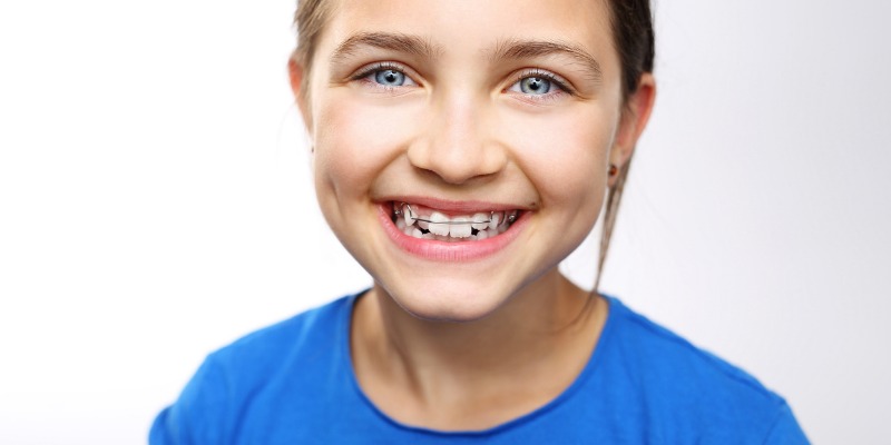 Smiling young girl who is happy with her early orthodontic treatment